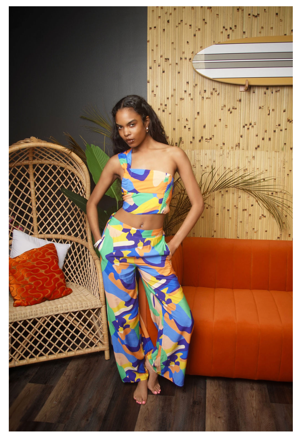 Abstract Isle Pant Set in multicolor abstract print — one-shoulder crop top with flowy wide leg pants in blue, orange, green and yellow
