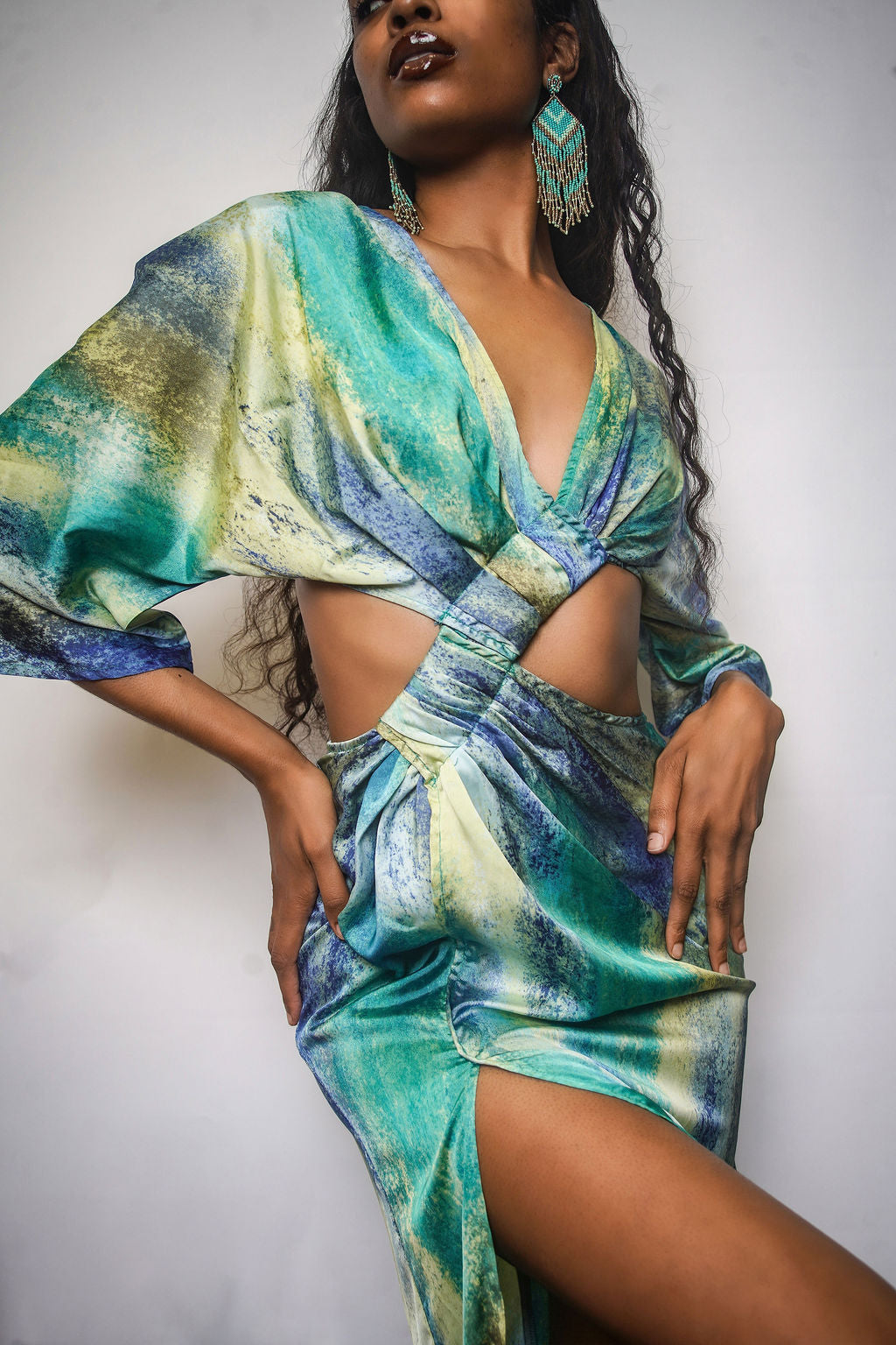 Bleu Hue Summer Dress in blue, green, and yellow watercolor print — deep V-neck, flutter sleeves, cutout midriff, and asymmetric thigh slit