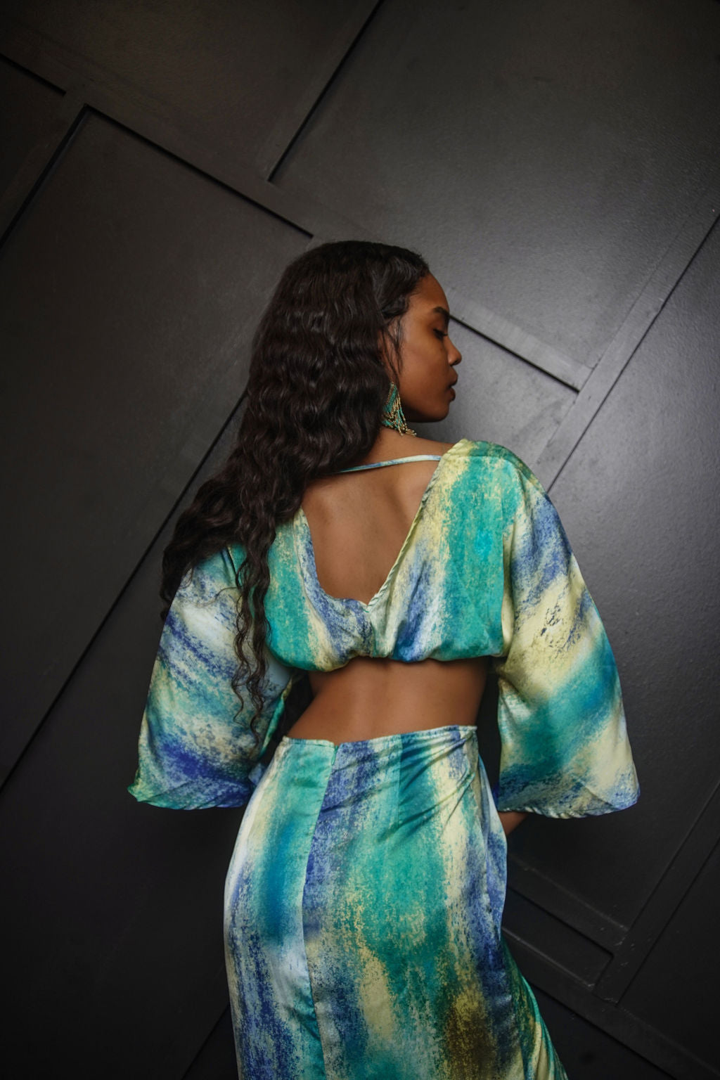 Bleu Hue Summer Dress in blue, green, and yellow watercolor print — deep V-neck, flutter sleeves, cutout midriff, and asymmetric thigh slit