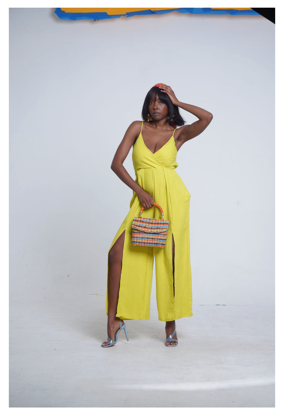 Lime Crush Jumpsuit in citrus yellow — deep V wrap neckline, spaghetti straps, wide leg with dual thigh slits and pockets