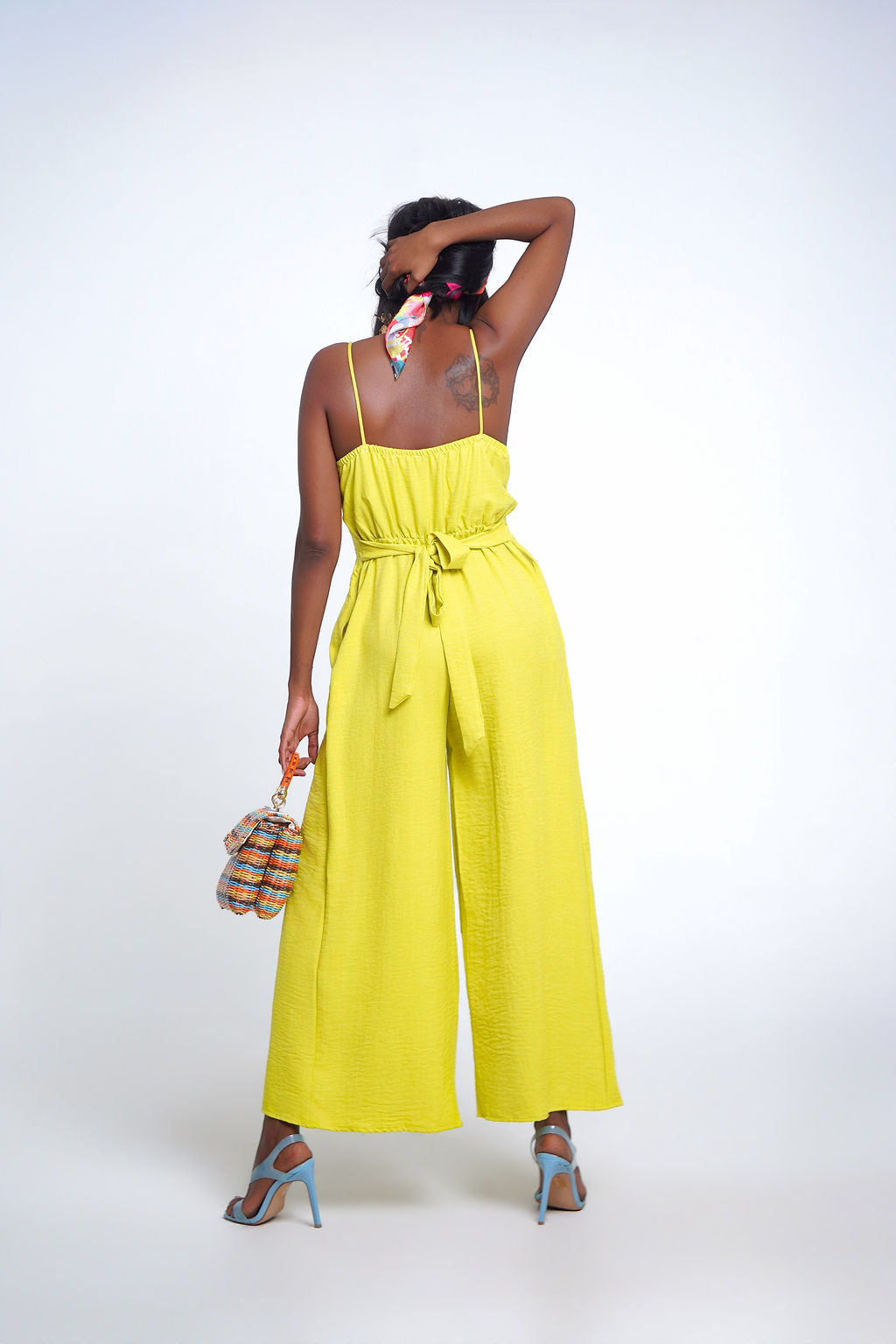 Lime Crush Jumpsuit in citrus yellow — deep V wrap neckline, spaghetti straps, wide leg with dual thigh slits and pockets